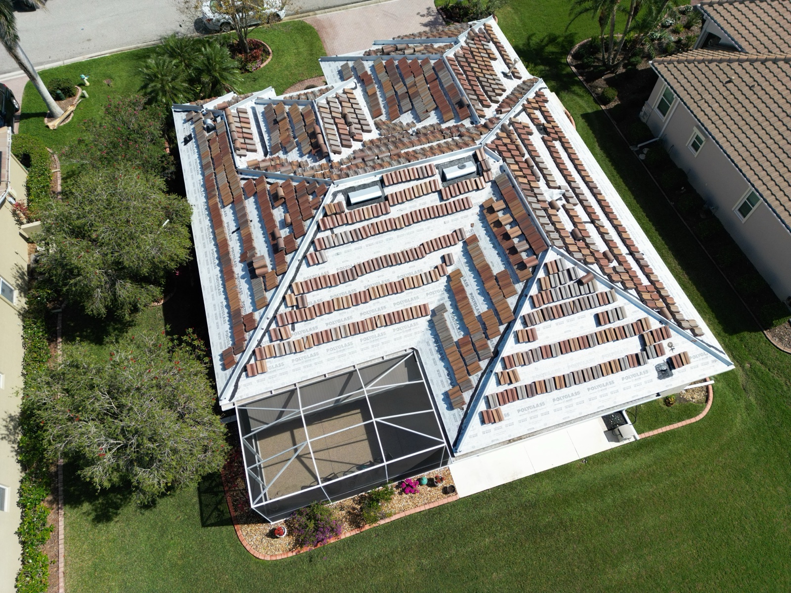 Tile roof installation in progress showing underlayment and tile layout